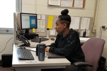 A girl sitting at a desk. 