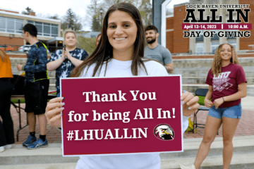 A woman holding a sign that says, "Thank You for being All In! #LHUALLIN