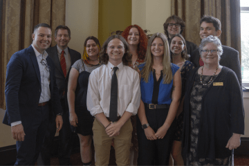 A group of people standing together for a photo. 