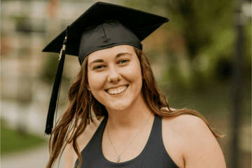 Headshot of a woman wearing a graduation cap. 