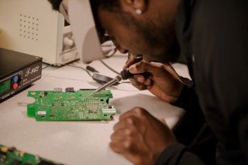 A man working on cyber equipment.