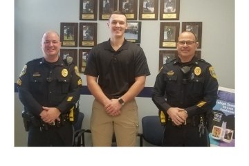 Three police officers standing side by side. 