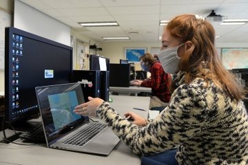 A woman working on a computer. 