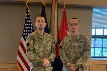 Two military men standing side by side.