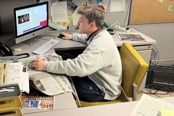 A guy sitting at a computer. 