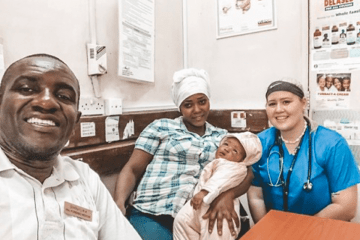 A nurse with parents and a baby.