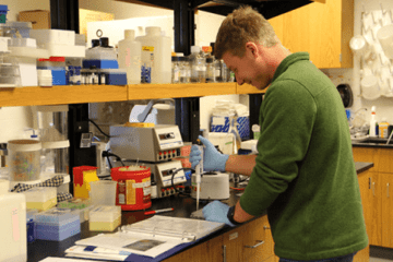 A man working in a lab setting. 