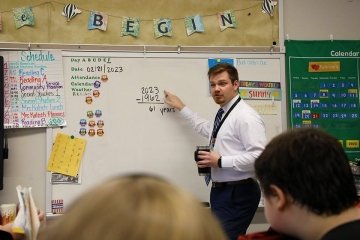 A man teaching a class. 