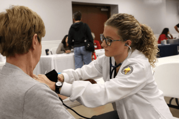 A nurse practicing on a patient. 