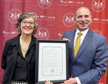 A man and a woman holding an award. 