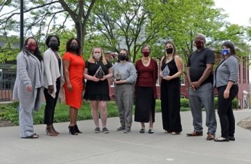 A group of people standing side by side. 