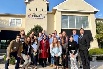 A group of people standing in front of a building. 