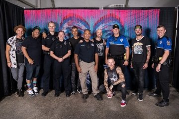 A group of people in first responder uniforms standing together. 