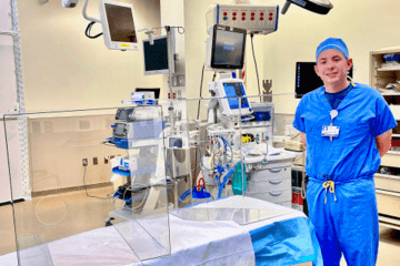 A person in scrubs in a medical environment. 