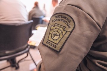 A close up of an officer patch on the sleeve. 