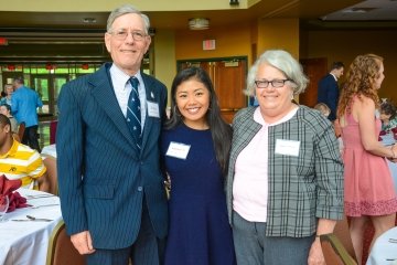 Three people standing side by side. 