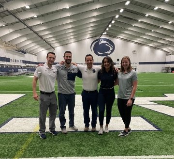 A group of people standing on a field. 