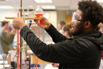 A Chemistry student at CU-Bloomsburg conducting an experiment in a lab