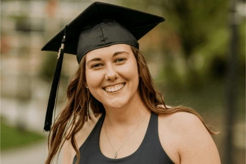 Headshot of a woman wearing a graduation cap. 