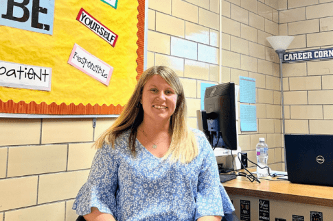 Shelby Johnson sitting in a classroom and smiling