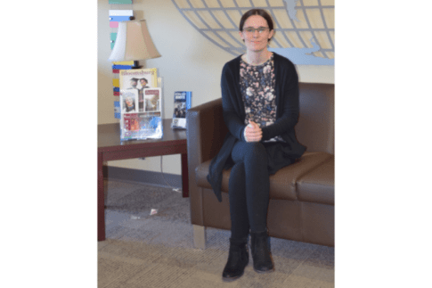 Morgan Edwards-Lewis ‘22 sits on a couch in the second floor lobby of Sutliff Hall