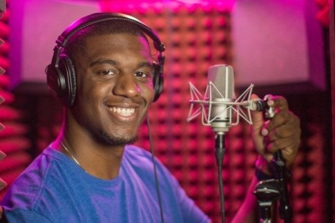 Enrique Josephs in a mic booth, smiling at the camera.