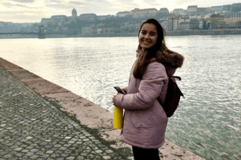 Student, O'Neill posing for photo next to water