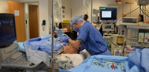 a nursing student practicing intubation on a dummy