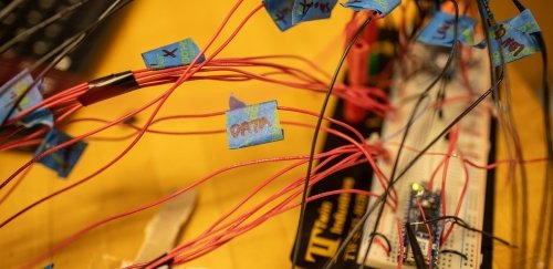 Red and black data cables connected to electronics board.