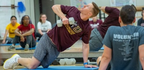 Dr. Haile demonstrates weigh training exercise in Exercise Science class at Commonwealth University