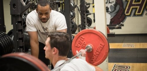 An Exercise Science grad student supervises a workout.