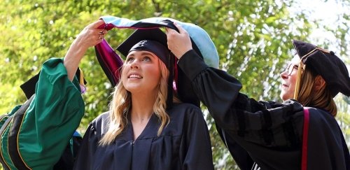 Female college graduate hooding