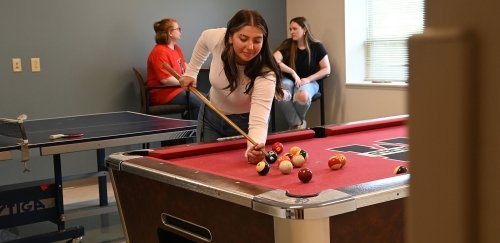 Female playing pool at Mansfield