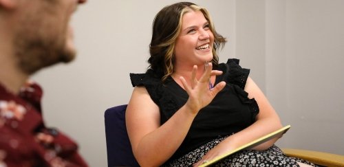 a msw student smiling in a discussion