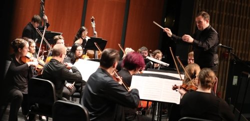 Orchestra students on stage with their instruments