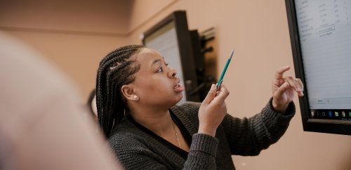 Student working on a spreadsheet in a supply chain management class