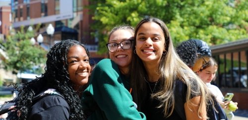 Students posing on campus walkway