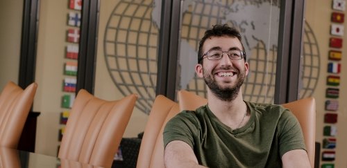 International business major listens in on a discussion at Sutliff Hall's conference room