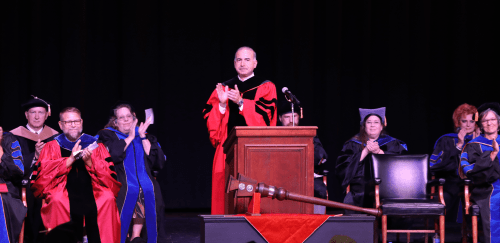 CU President Bashar Hanna clapping during a Fall commencement ceremony