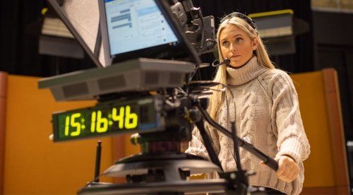 Female student operating camera in TV studio at CU-Bloomsburg