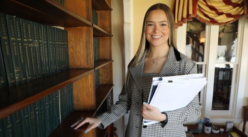 Riley Kleinfelter standing in the law office of Loomis|Koering