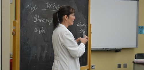 Nursing instructor in lab coat