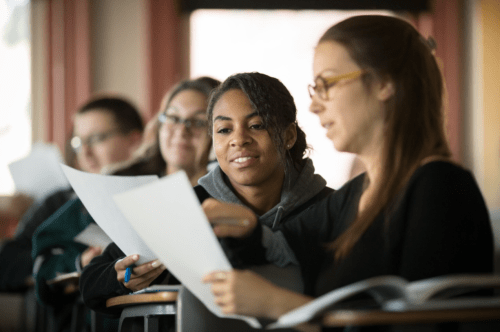 Students working with papers in hand.