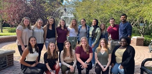 AuD Audiology students posing for a photo in front of a fountain