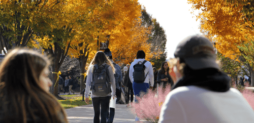 Students walking on campus in fall