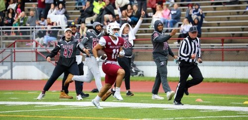 Football player runs for a touchdown at Commonwealth University-Lock Haven, formerly Lock Haven University.