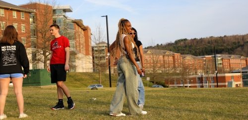 Friends enjoy the sunset of a spring evening at Commonwealth University-Mansfield, formerly Mansfield University.