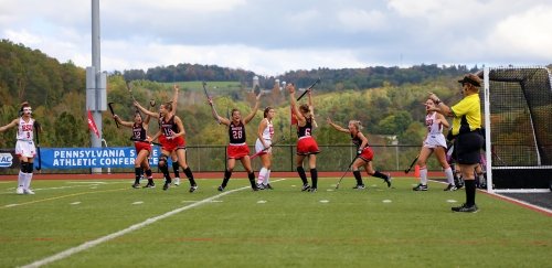 Field hockey players celebrate a goal at Commonwealth University-Mansfield, formerly Mansfield University