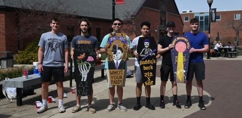 Commonwealth University-Mansfield, formerly Mansfield University, Greek Life students in a fraternity stand on South Hall Mall with sorority signs