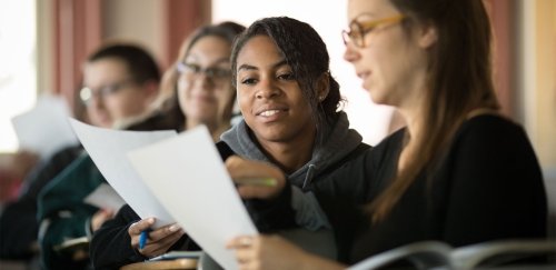 Students working with papers in hand.